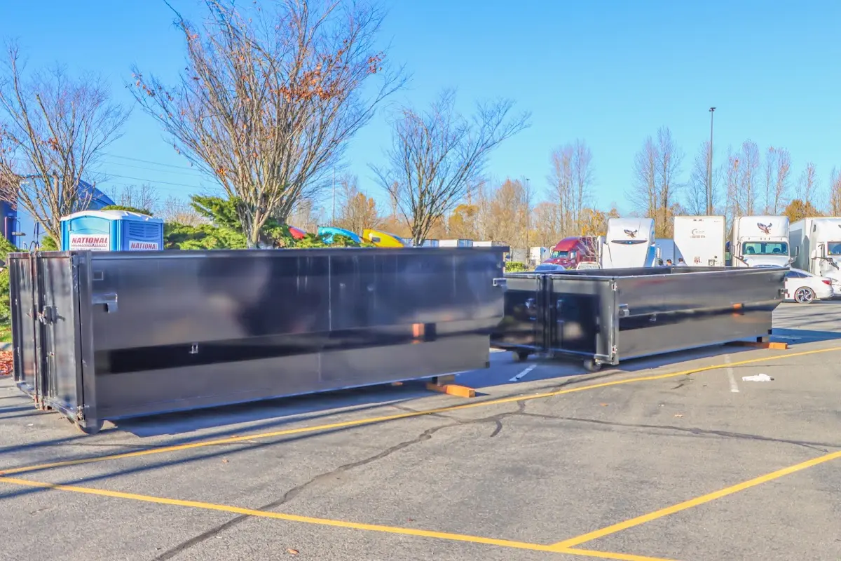 Professional dumpster rental service with roll-off container on residential driveway in Livonia